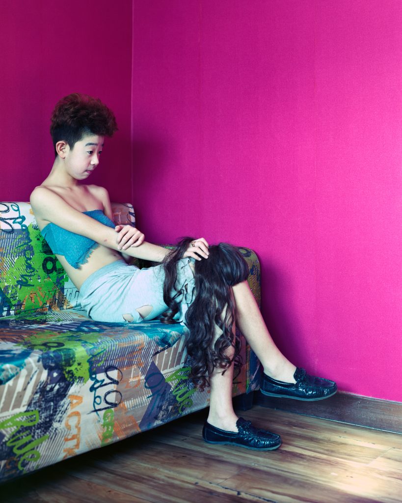 Ronghui Chen, Freezing Land, portrait against a pink wall